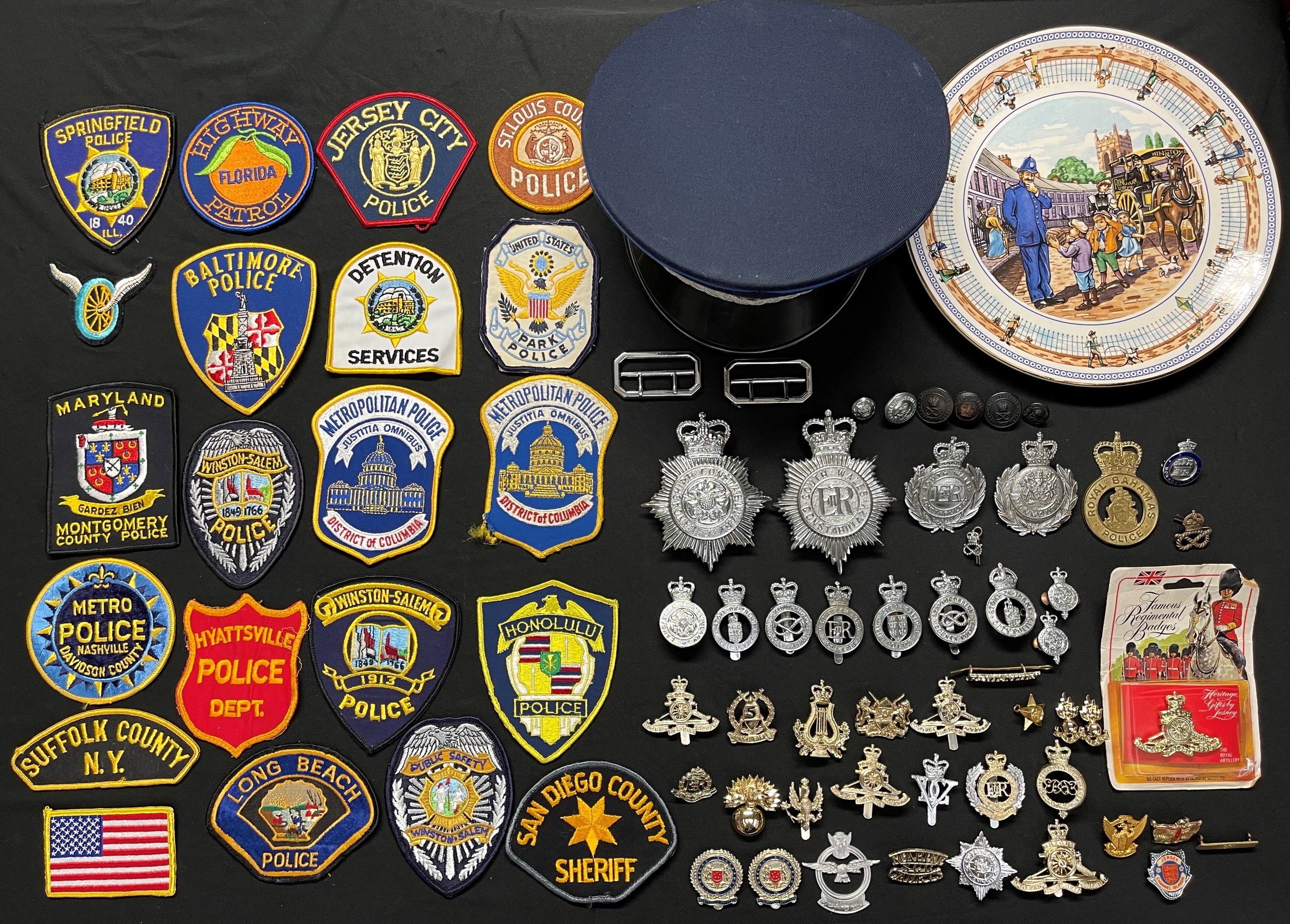 A collection of Queens Crown Police Helmet Plates and cap ba...