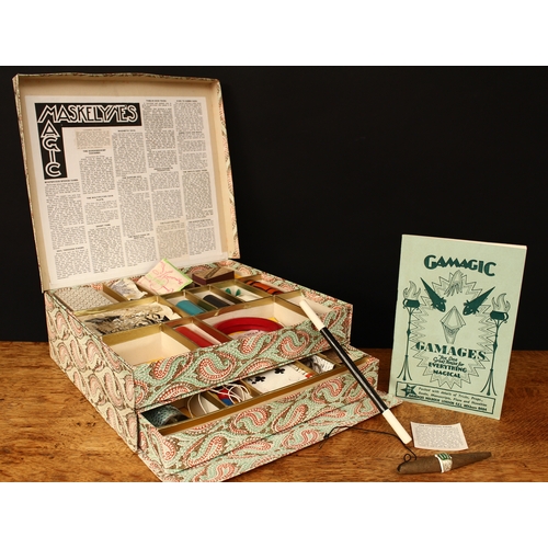 3334 - A 1950's Maskelyne's Mysteries box of conjuring tricks by Gamages, Holborn of London, comprising a t... 