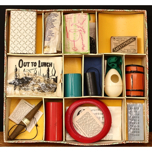 3334 - A 1950's Maskelyne's Mysteries box of conjuring tricks by Gamages, Holborn of London, comprising a t... 