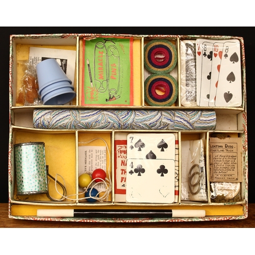 3334 - A 1950's Maskelyne's Mysteries box of conjuring tricks by Gamages, Holborn of London, comprising a t... 