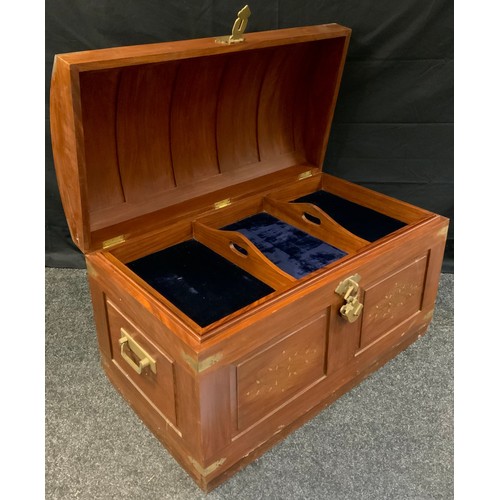 283 - A 20th century teak, domed-top trunk, brass inlay with foliate scrolls, the interior with lift-out t... 