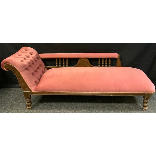 382 - A late Victorian mahogany chaise longue, upholstered in pink, turned spindles and feet, c.1870, 65cm... 