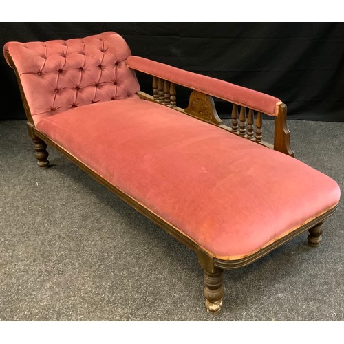 382 - A late Victorian mahogany chaise longue, upholstered in pink, turned spindles and feet, c.1870, 65cm... 