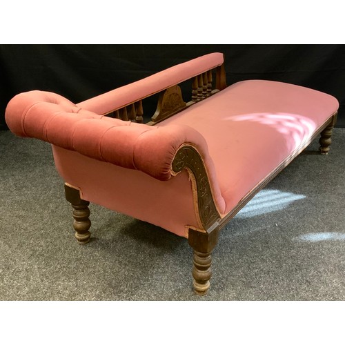 382 - A late Victorian mahogany chaise longue, upholstered in pink, turned spindles and feet, c.1870, 65cm... 