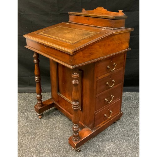 403 - A late Victorian Mahogany Davenport, sloped writing surface, fitted interior, four side drawers, tur... 