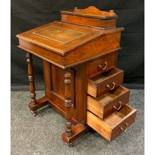 403 - A late Victorian Mahogany Davenport, sloped writing surface, fitted interior, four side drawers, tur... 