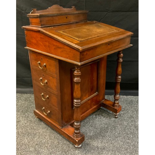 403 - A late Victorian Mahogany Davenport, sloped writing surface, fitted interior, four side drawers, tur... 