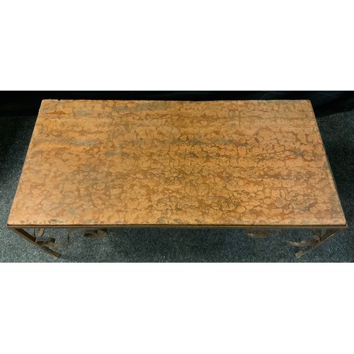 401 - A wrought iron marble topped rectangular coffee table, veined peach top, scrolled spiralled legs, 43... 