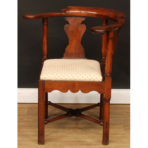 1 - A George III walnut and mahogany corner chair, curved arms terminating in outswept hand rests, turne... 