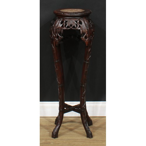 16 - A Chinese hardwood jardiniere stand, circular top with inset soapstone panel, above a shaped frieze ... 