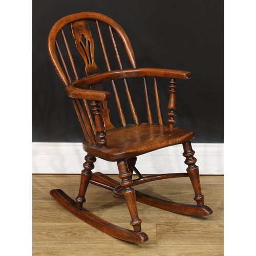 19 - A 19th century child’s Windsor rocking chair, 65.5cm high, 38cm wide, the seat 28cm wide and 23cm de... 