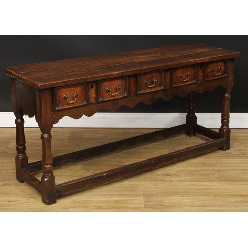 118 - A Charles II style oak dresser, moulded cornice above a pair of plate racks, the upper flanked by op... 