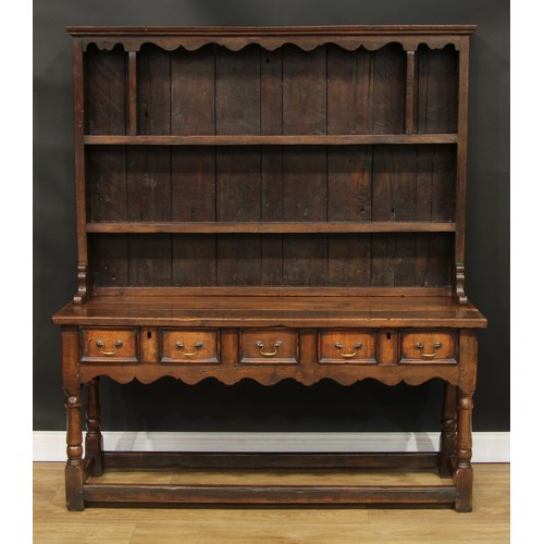 118 - A Charles II style oak dresser, moulded cornice above a pair of plate racks, the upper flanked by op... 