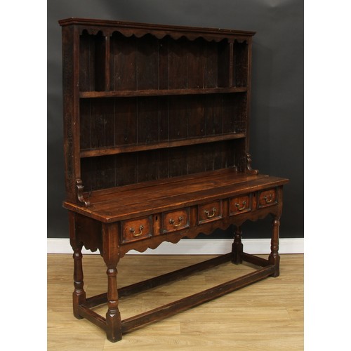 118 - A Charles II style oak dresser, moulded cornice above a pair of plate racks, the upper flanked by op... 