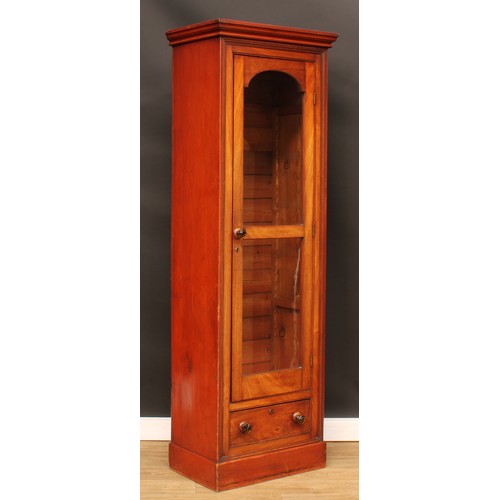 120 - A Victorian mahogany and pine cabinet, moulded cornice above a glazed door and a drawer, plinth base... 