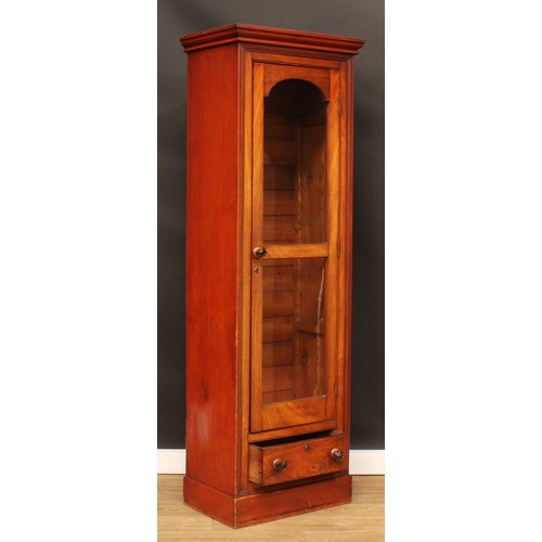 120 - A Victorian mahogany and pine cabinet, moulded cornice above a glazed door and a drawer, plinth base... 