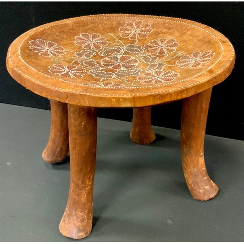 73 - An African stool, painted dished seat, with traditional motifs, 30cm high, 39cm diameter