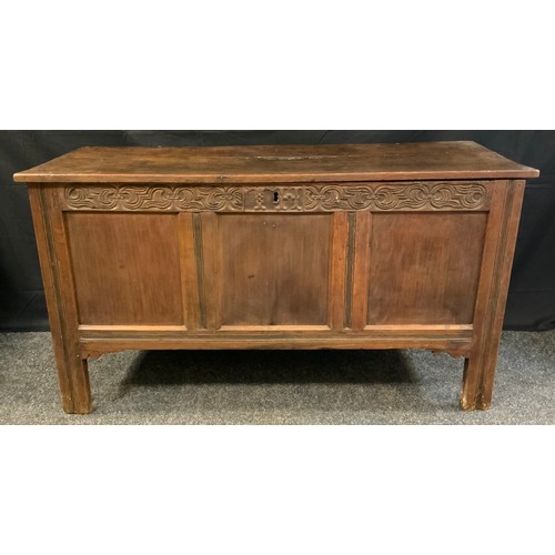 77 - An 18th century oak blanket box, c.1760

planked top, three panelled  front, the frieze carved with ... 