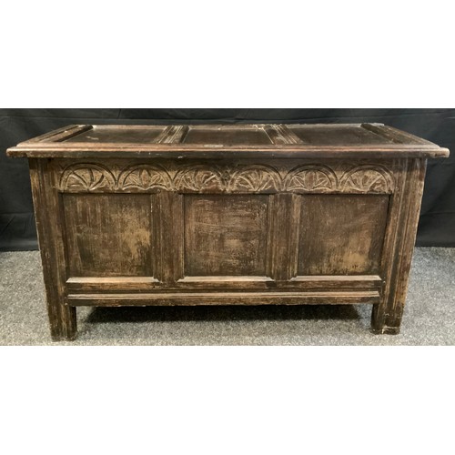 96 - An 18th century oak blanket box, c.1760

three panelled top and front, carved lunette frieze, stile ... 