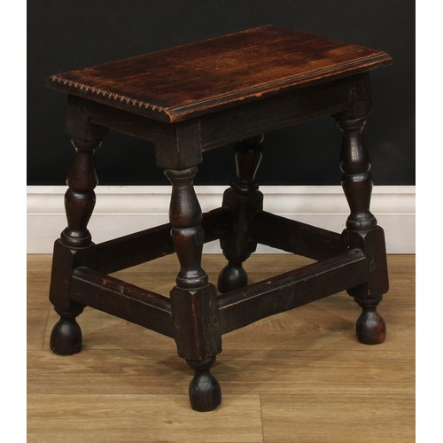 274 - A 19th century oak joined stool, oversailing rectangular top with notched ends, turned legs, moulded... 