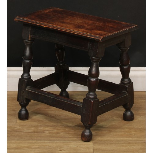 274 - A 19th century oak joined stool, oversailing rectangular top with notched ends, turned legs, moulded... 