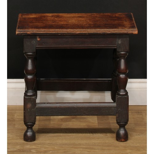 274 - A 19th century oak joined stool, oversailing rectangular top with notched ends, turned legs, moulded... 