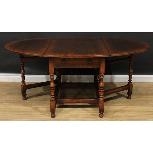 275 - An 18th century style oak gateleg dining table, by Titchmarsh & Goodwin, oval top with fall leaves, ... 