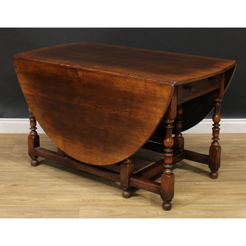 275 - An 18th century style oak gateleg dining table, by Titchmarsh & Goodwin, oval top with fall leaves, ... 