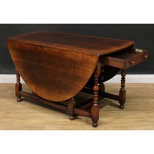 275 - An 18th century style oak gateleg dining table, by Titchmarsh & Goodwin, oval top with fall leaves, ... 