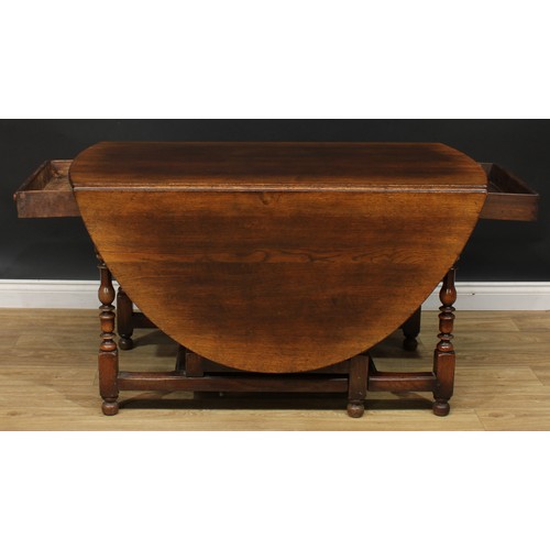 275 - An 18th century style oak gateleg dining table, by Titchmarsh & Goodwin, oval top with fall leaves, ... 