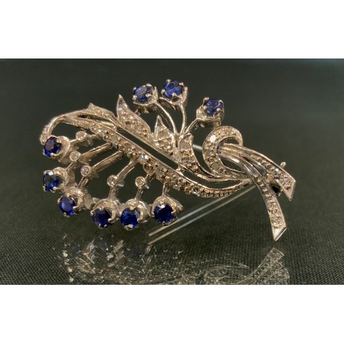 699 - An 18ct white gold diamond and sapphire leaf shaped floral spray brooch, unmarked, 6.6g, 4.5cm, Mapp... 