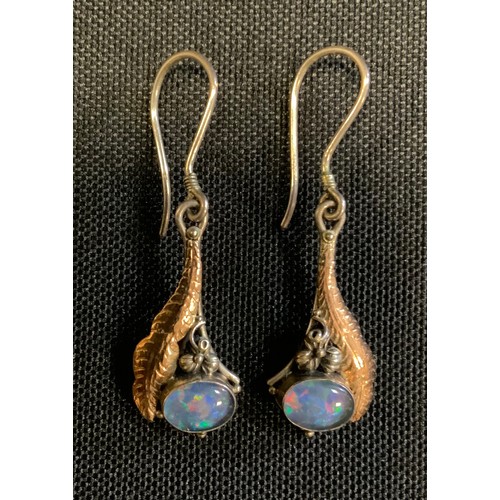 705 - A pair of silver and yellow metal opal cabochon drop earrings, silver hook suspending a gold and sil... 