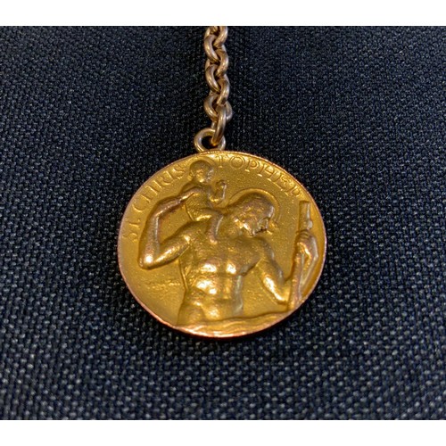 707 - Betty Davis interest - a nine carat gold St. Christopher's medallion, 5.1g, suspended on a base meta... 