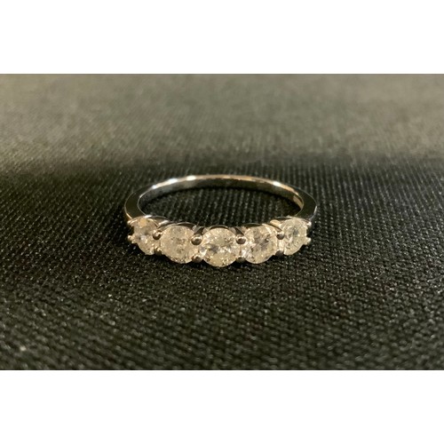 710 - A diamond ring, linear set with five round brilliant cut diamonds, total estimated diamond weight ap... 