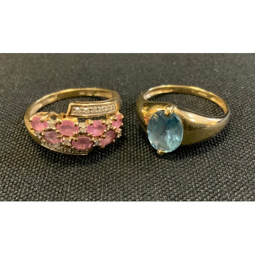 714 - A 9ct gold diamond and pink stone ring, stamped 9K 375 Qvc, size P, 2.8g gross;  another blue topaz ... 