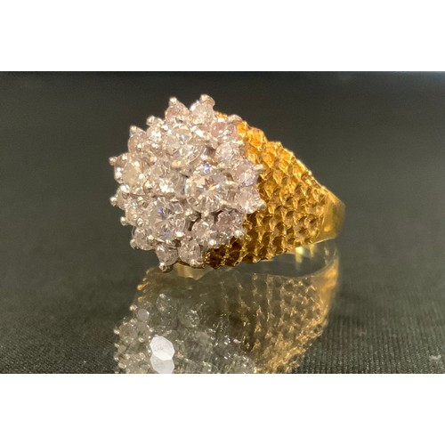 718 - An 18ct gold diamond cluster ring, the central brilliant cut stone surrounded by four 0.2ct stones, ... 