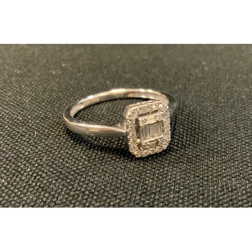 719 - A modern diamond ring, set with five baguette and twenty five round brilliant cut diamonds, 9ct whit... 