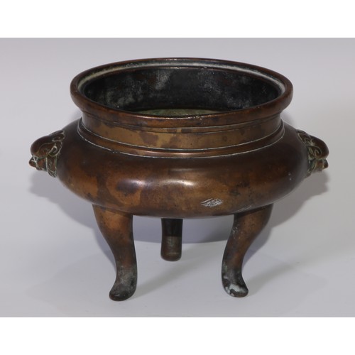 57 - A Chinese bronze tripod censer, cast temple lion mask handles, tall serpentine legs, 16cm wide, 19th... 