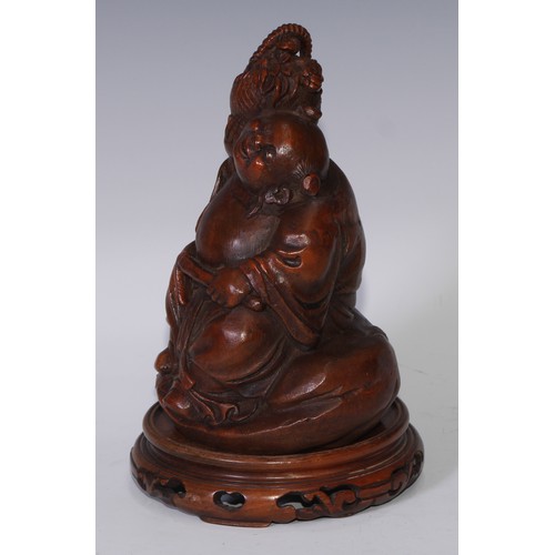 59 - A Chinese bamboo figure, carved as Budai holding a basket of flowers, 19.5cm high, pierced hardwood ... 