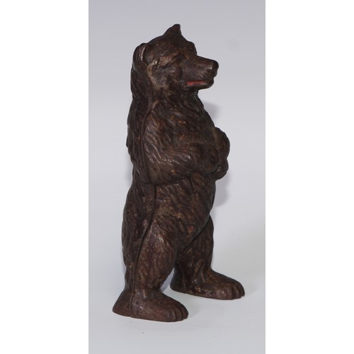 93 - An early 20th century cast iron novelty money box, as a bear, 16.5cm high