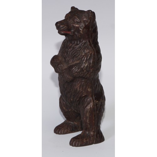 93 - An early 20th century cast iron novelty money box, as a bear, 16.5cm high