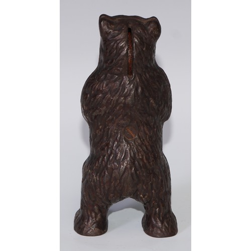 93 - An early 20th century cast iron novelty money box, as a bear, 16.5cm high