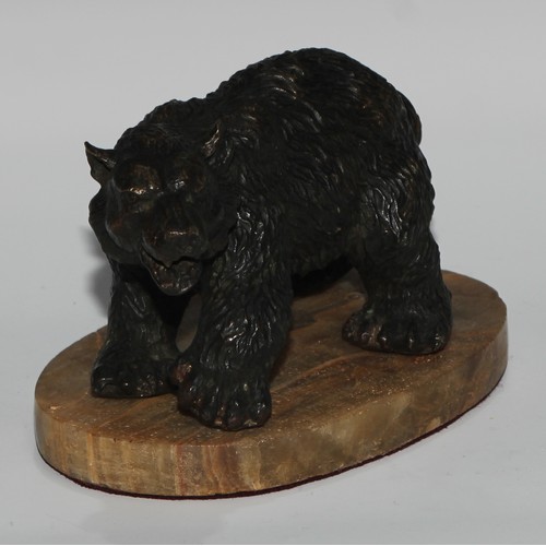 122 - Continental School, a dark patinated bronze, of a bear, oval base, 19cm long