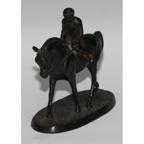 135 - A Continental dark patinated equestrian desk sculpture, cast as a horse and jockey, oval base, 17cm ... 