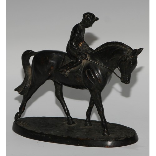 135 - A Continental dark patinated equestrian desk sculpture, cast as a horse and jockey, oval base, 17cm ... 