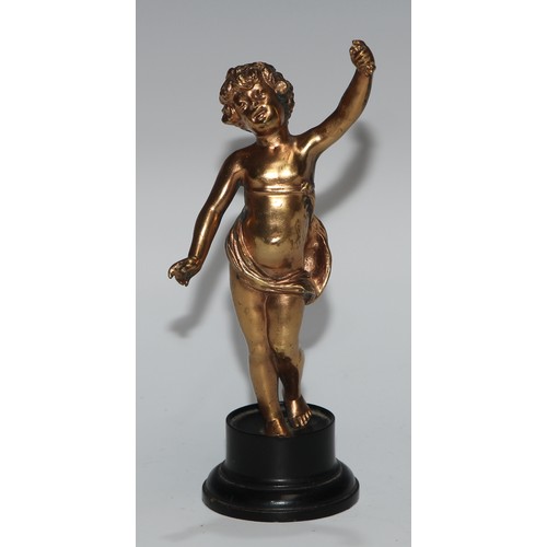 186 - A Continental gilt metal figure, cast as a putto, ebonised base, 17cm high