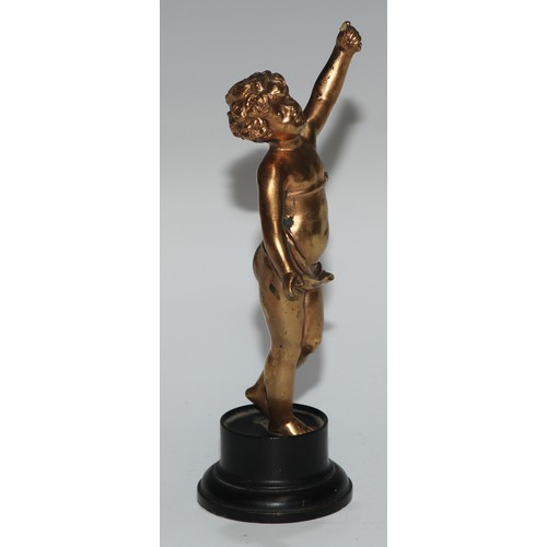 186 - A Continental gilt metal figure, cast as a putto, ebonised base, 17cm high