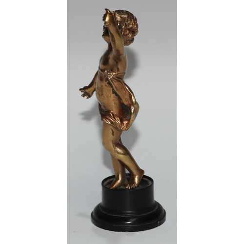 186 - A Continental gilt metal figure, cast as a putto, ebonised base, 17cm high