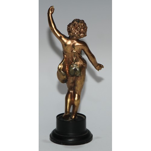 186 - A Continental gilt metal figure, cast as a putto, ebonised base, 17cm high