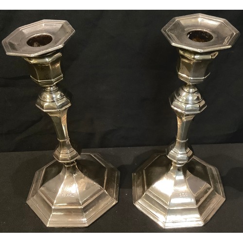 196 - A pair of Edwardian silver candlesticks, William Hutton & Sons Ltd, Sheffield 1909